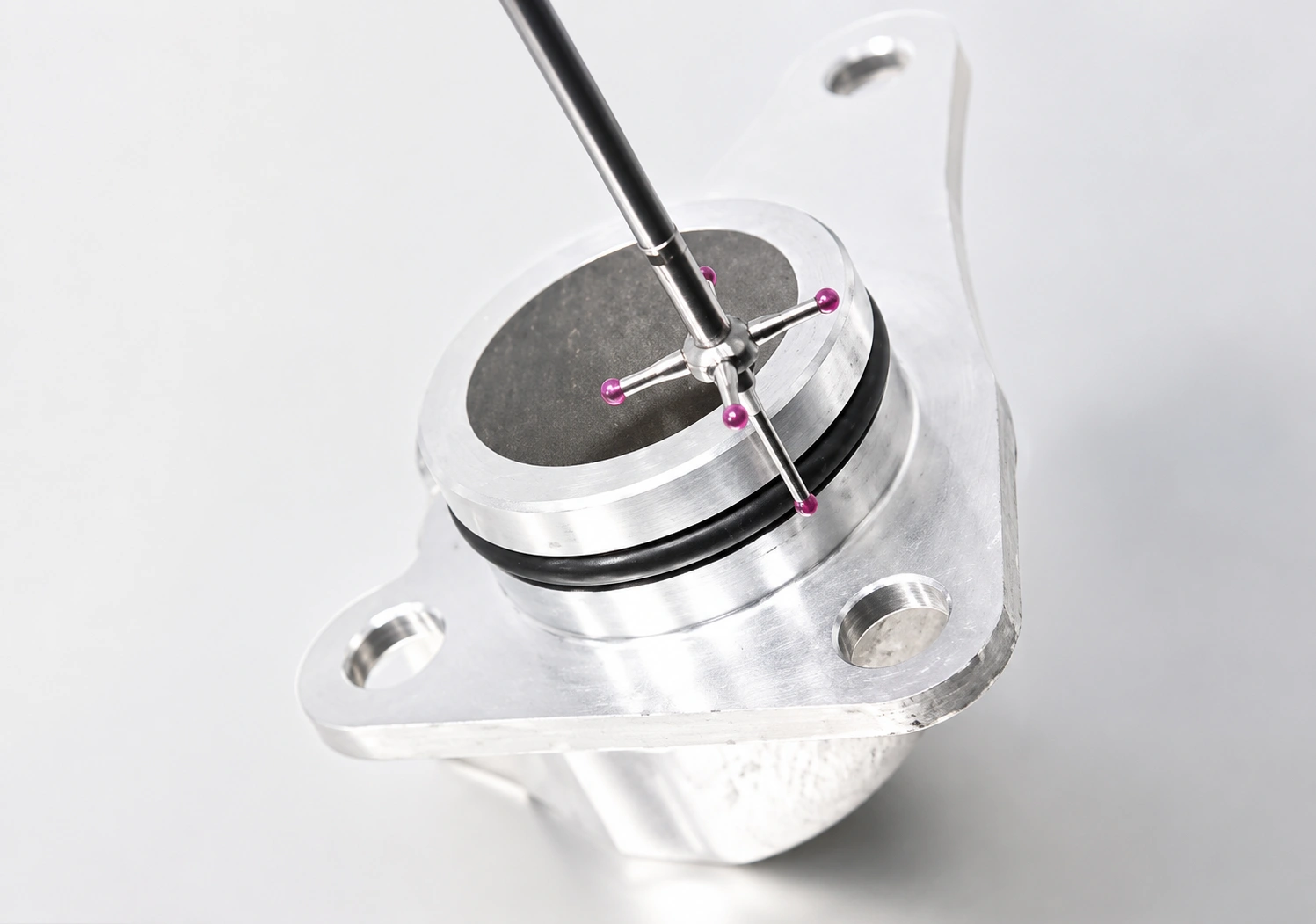 CMM touch probe inspecting a precision-machined component