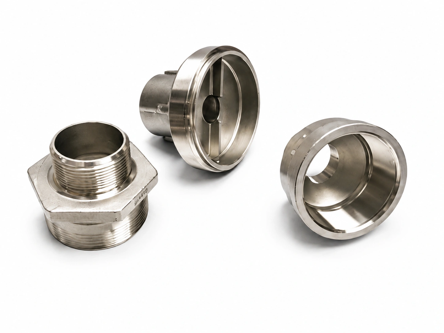 Precision investment-cast stainless steel valve and fitting components with machined threads and internal bores on a white background